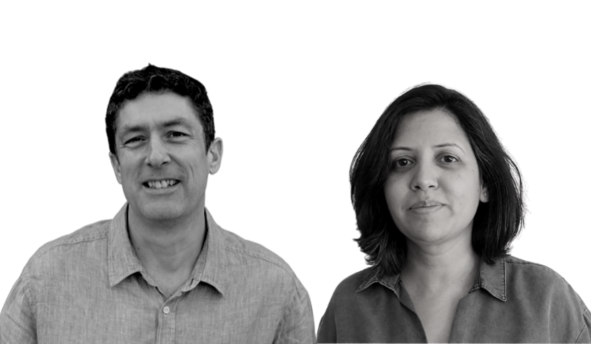 Colleagues Reshma and Jason in black and white face camera